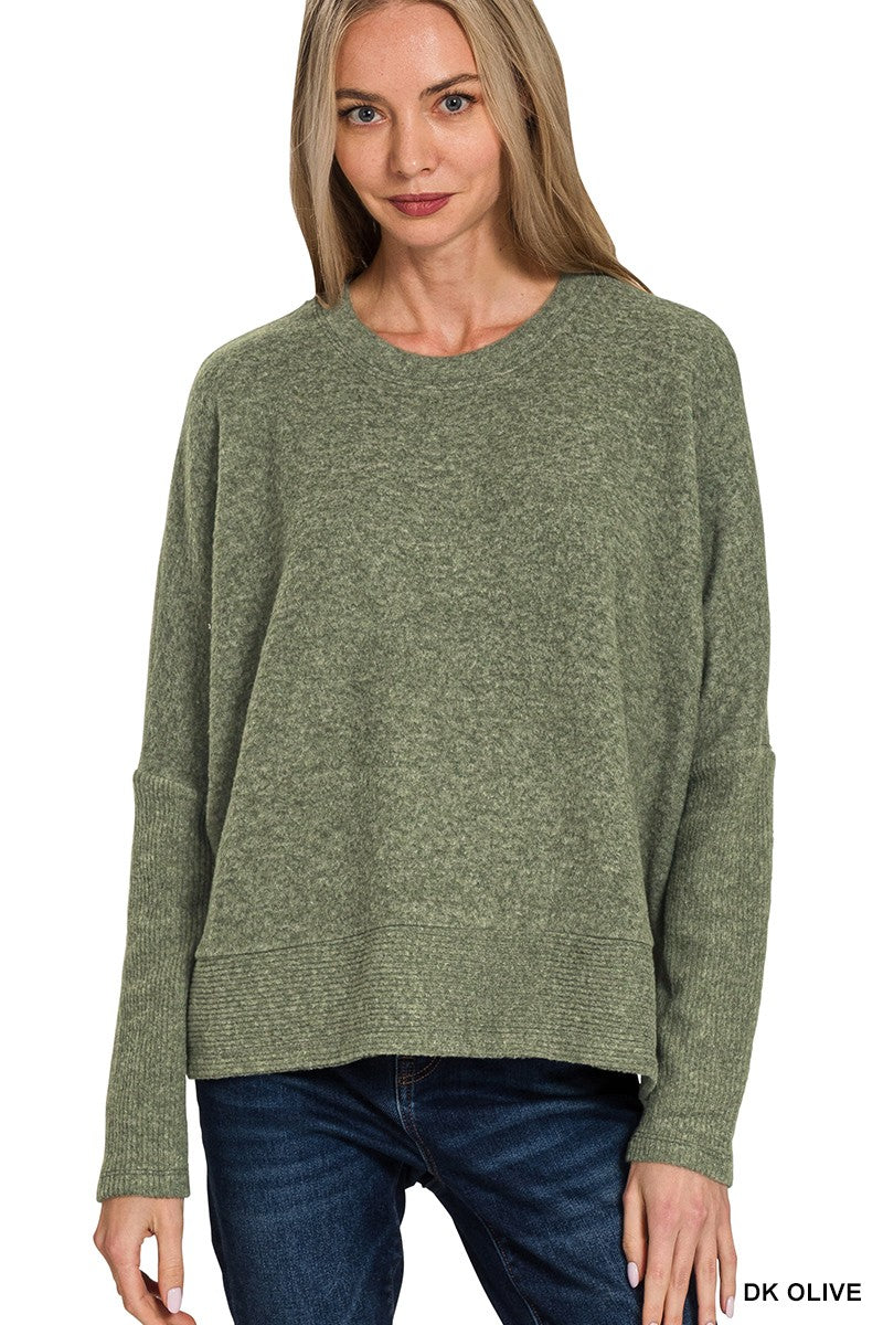 Woman wearing a green sweater on a white background