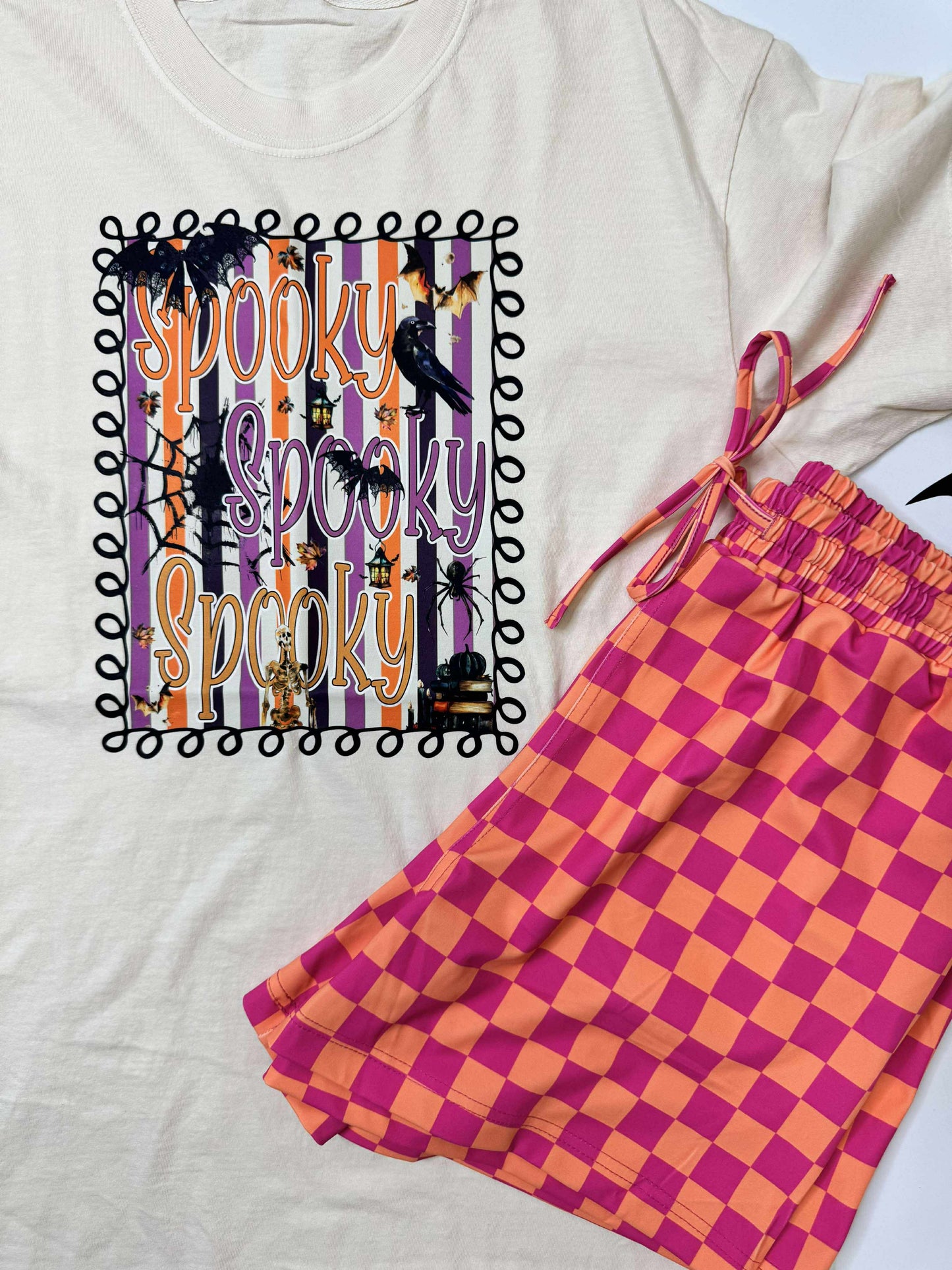 Halloween-themed t-shirt with checkered pants on a white background