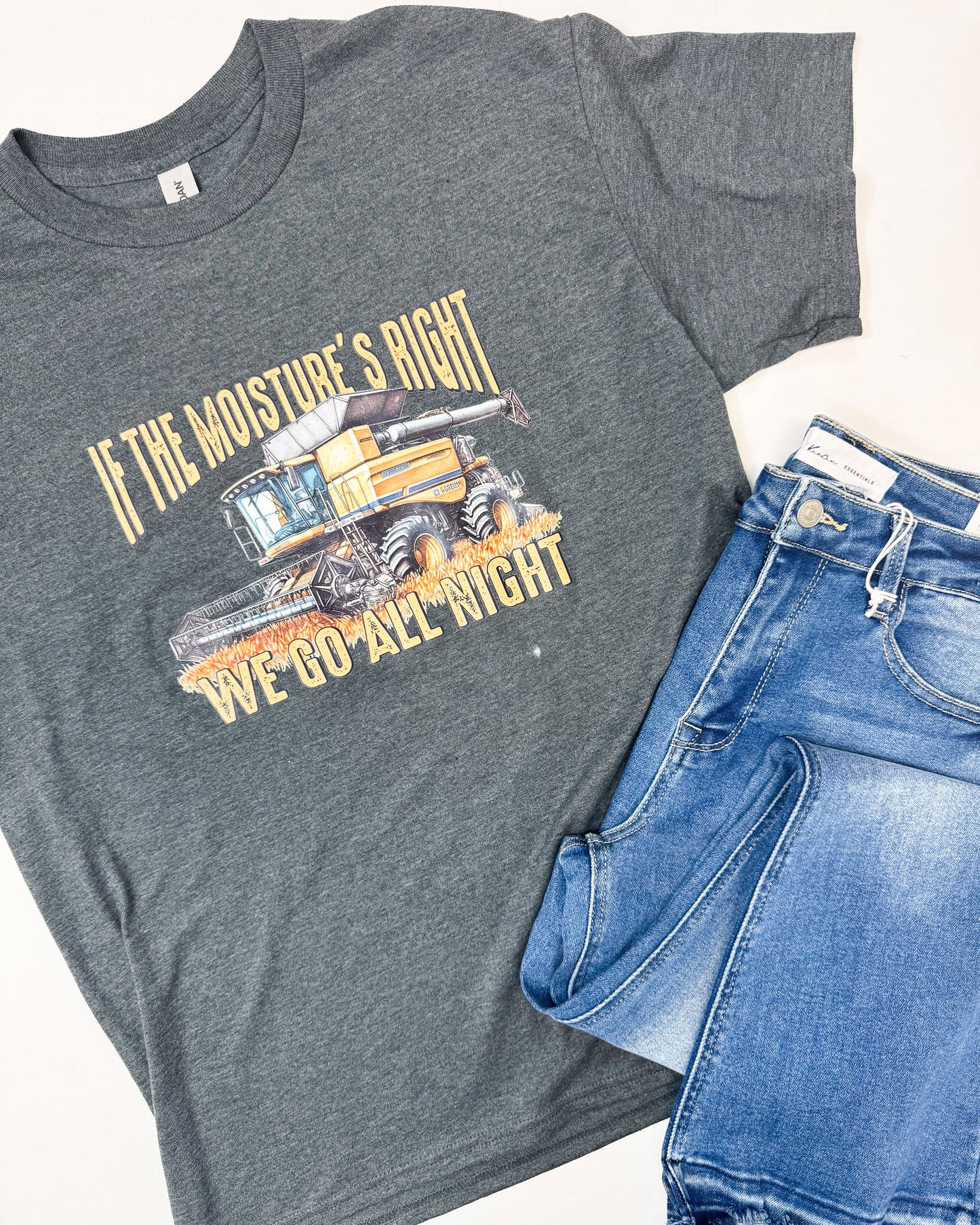 Gray t-shirt with a graphic design and jeans on a white background