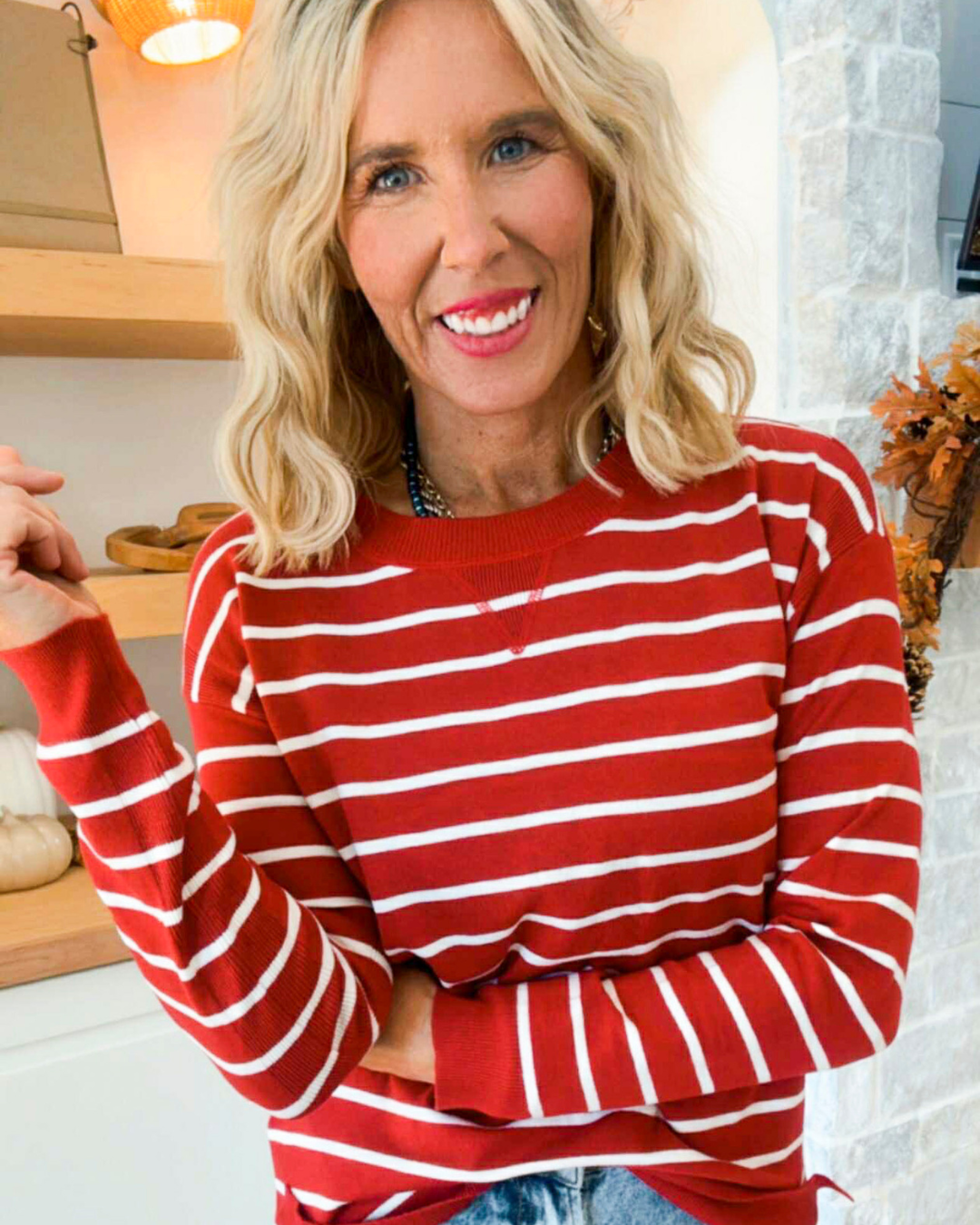 Woman wearing a red and white striped sweater in a kitchen setting