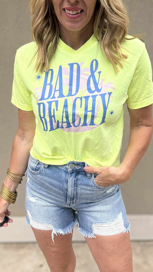 Garment dyed graphic crop top with bold lettering and frayed jean shorts.