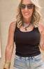 Classic black tank top styled with high-rise frayed denim shorts.