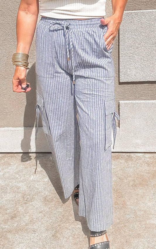 Blue and white striped wide leg cargo pants with drawstring waist.