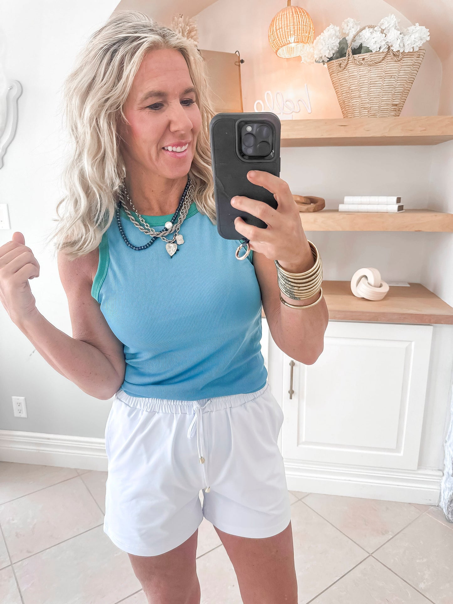 Colorblock athletic tank in vibrant blue and green paired with white shorts.