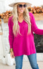 pink exposed seam sweater
