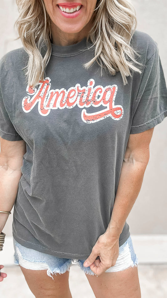 Patriotic retro-style America tee paired with frayed high-rise jean shorts.