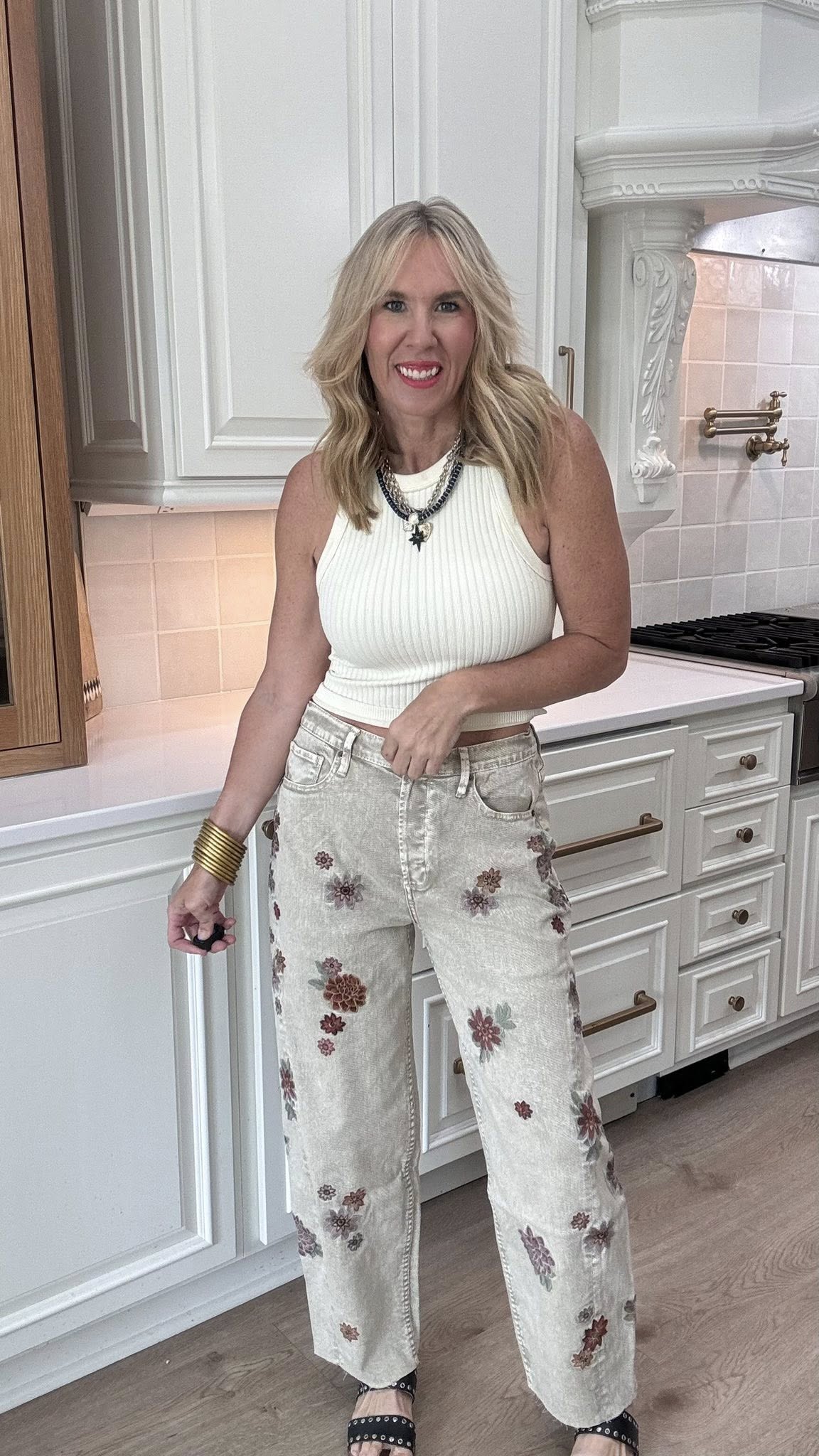 Washed grey jeans featuring floral embroidered detail and contrast side panels.