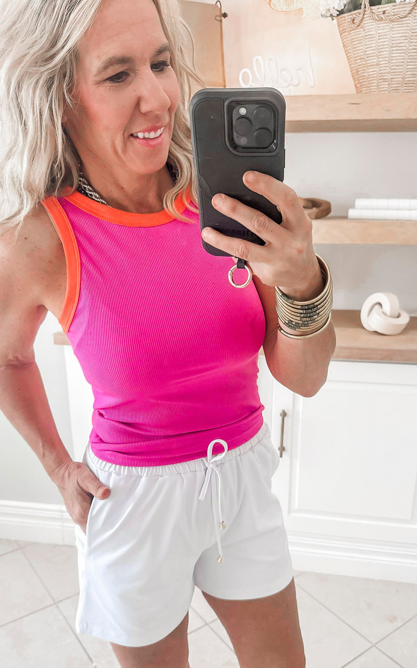 Vibrant pink-orange contrast tank top perfect for summer workouts or casual wear.