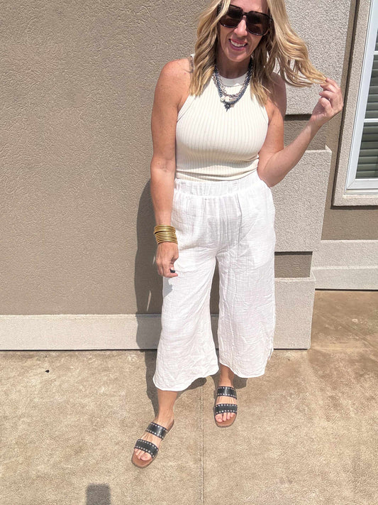 Cropped white gauze pants with comfy fit styled with a sleeveless knit tank.