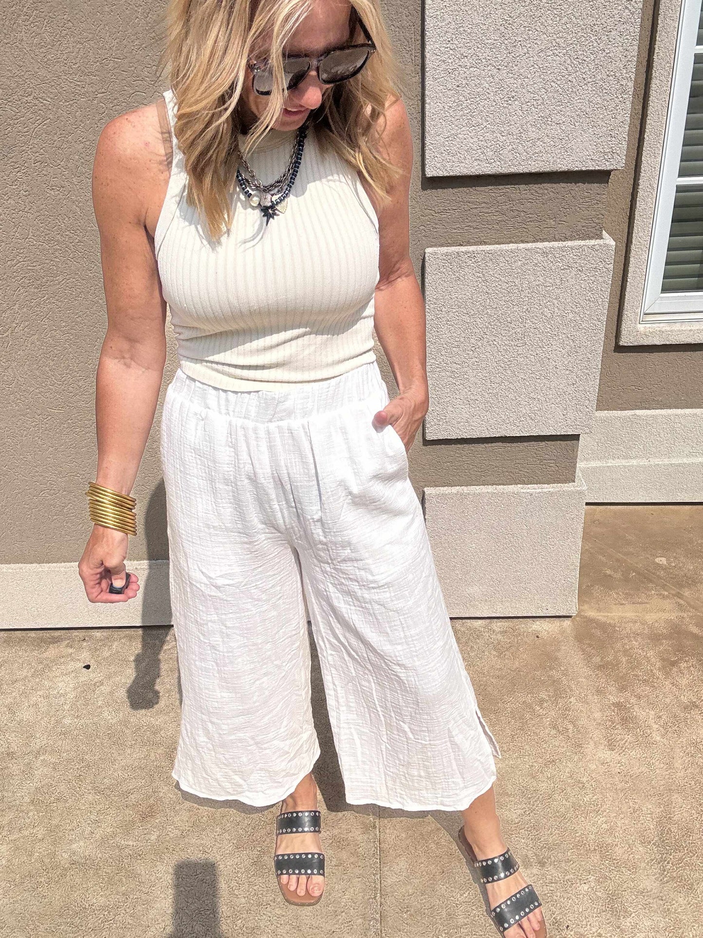 Lightweight white cropped gauze pants paired with fitted ribbed tank top.