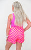 Woman wearing a pink checkered outfit on a white background