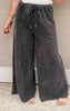 Relaxed fit mineral-washed black pants featuring front seam detail and slouchy pockets.