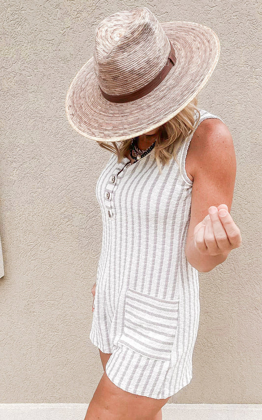 Textured stripe jacquard romper with button front and relaxed fit.