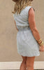 Sleeveless washed denim dress with vertical stripes and front patch pockets.