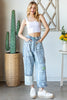Wide leg patchwork denim jeans with distressed panels and contrast cuff