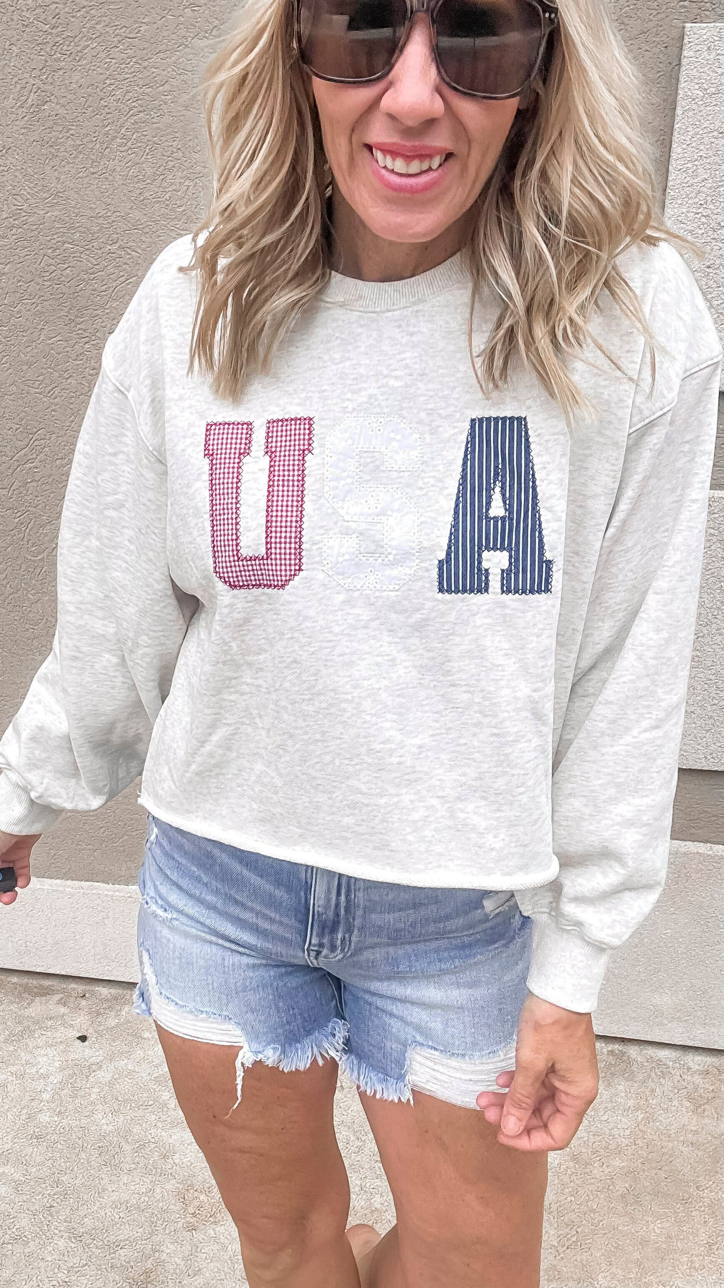 USA crewneck sweatshirt with red, white, and blue patch lettering.