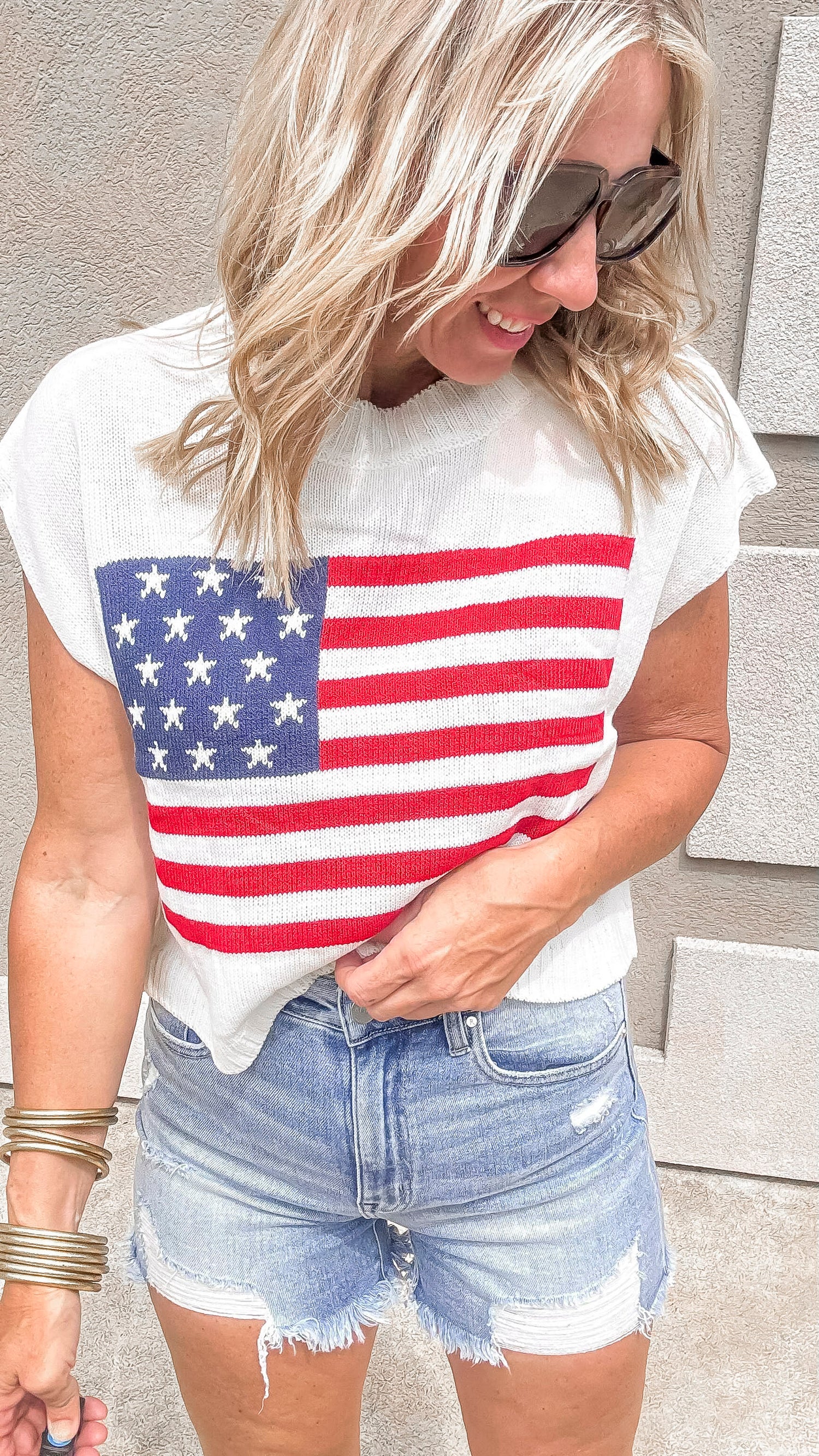 Patriotic sleeveless sweater top featuring U.S. flag design