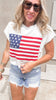 Casual patriotic knit top with bold flag graphic and raw hem.