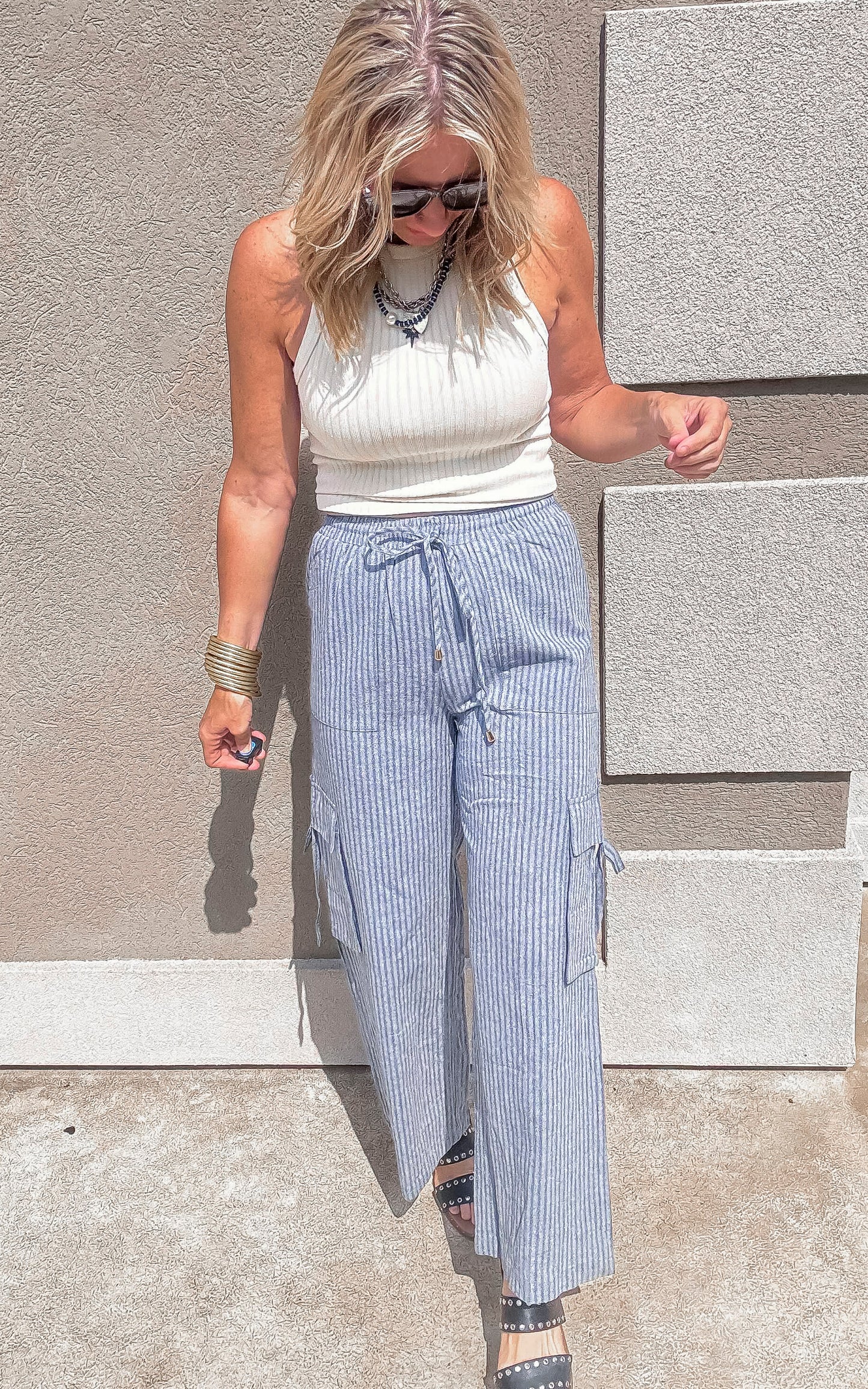 Summer-ready wide leg cargo pants styled with a ribbed white tank top.
