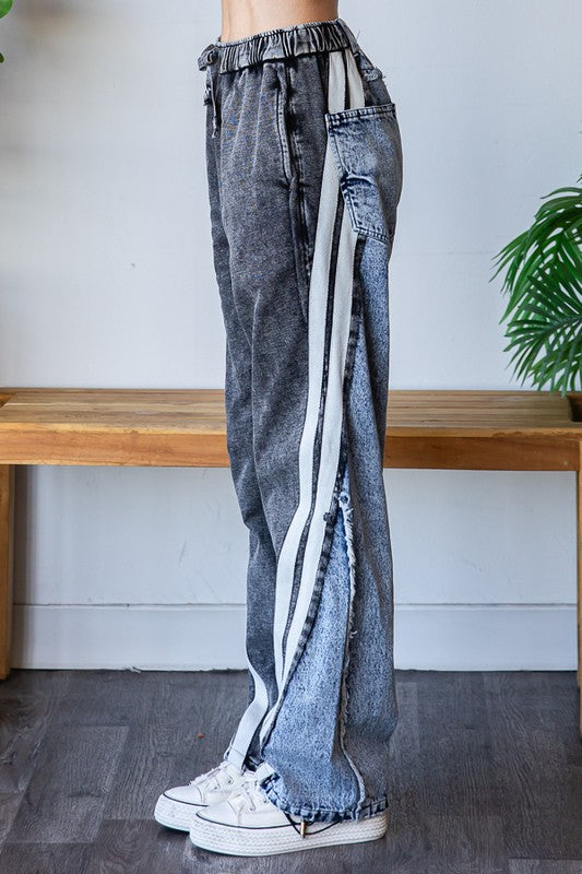 Washed wide leg jeans featuring color block panels and sporty side stripe.