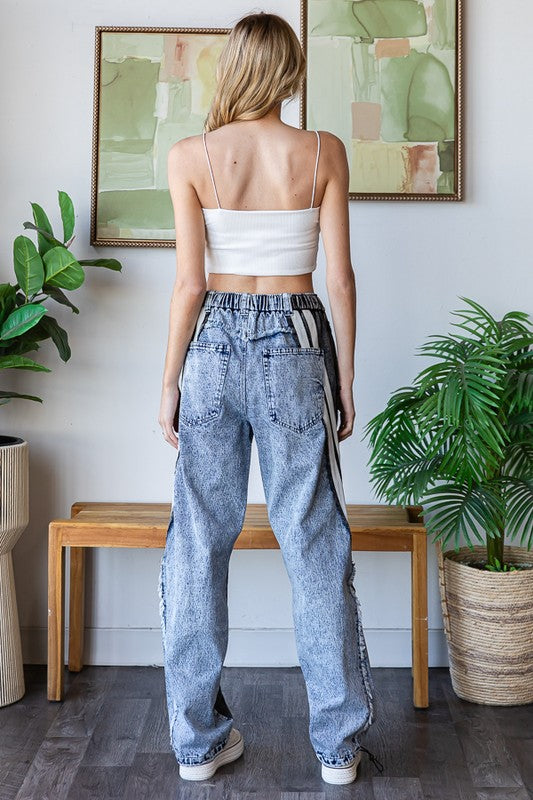 High rise oversized denim pants with elastic waist and bold contrast design.
