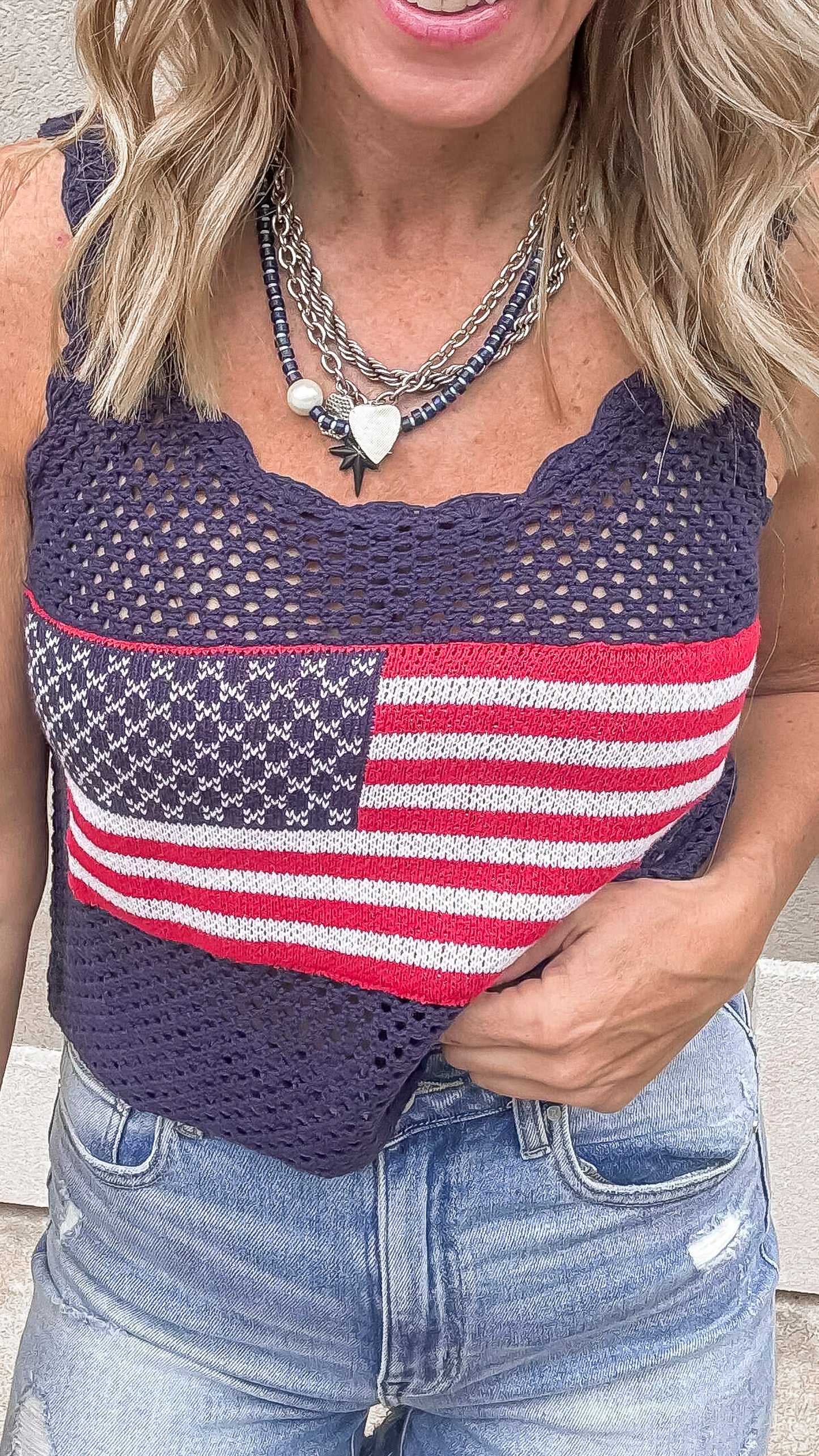 Navy USA crochet knit tank top styled with ripped denim shorts.