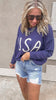 Retro-inspired knit USA sweater styled with frayed jean shorts.