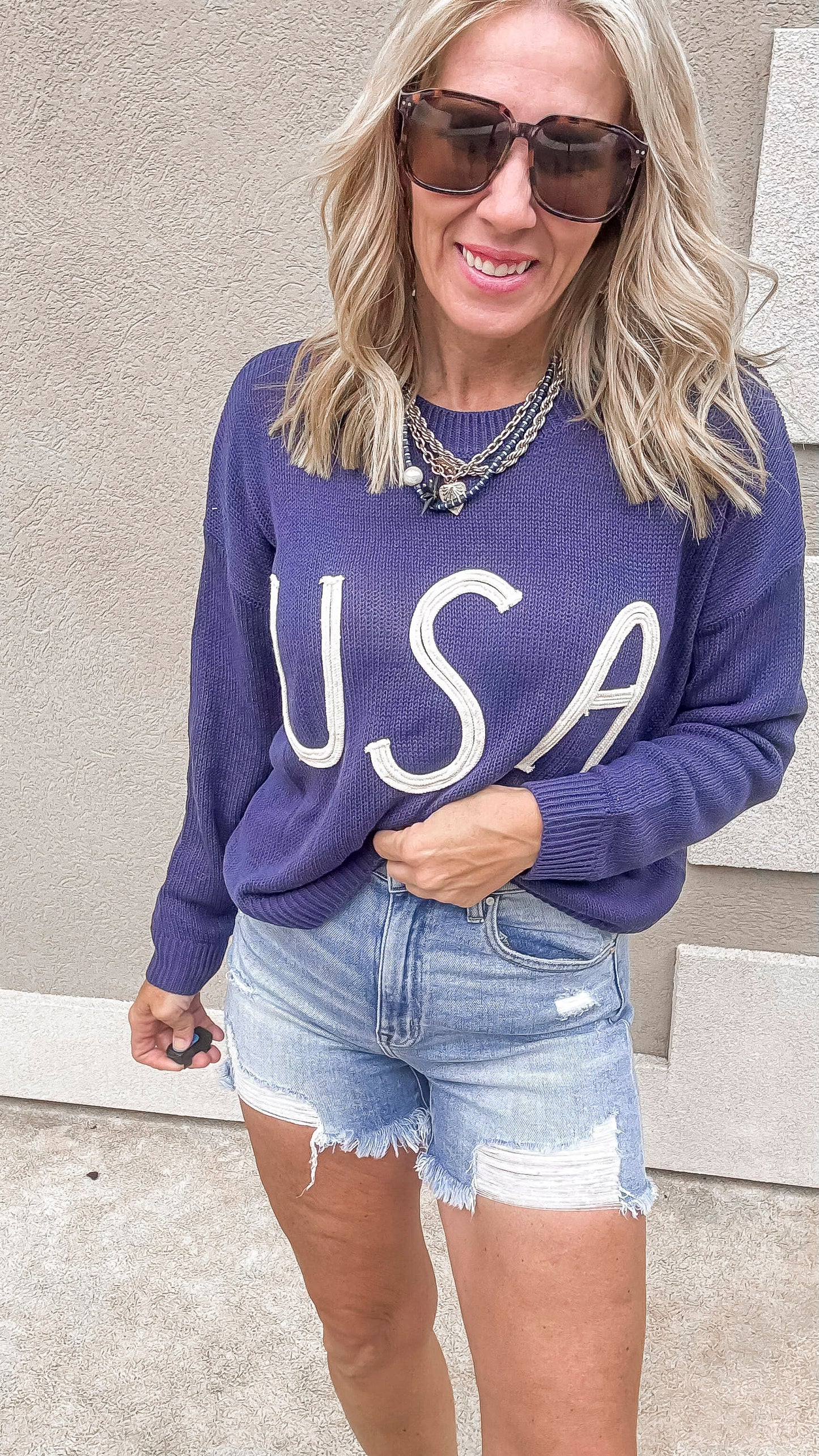 Classic USA lettered sweater in navy with high-rise cutoff shorts.