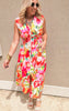 Colorful sleeveless dress featuring bold flower print, zip closure, and cinched waistline.