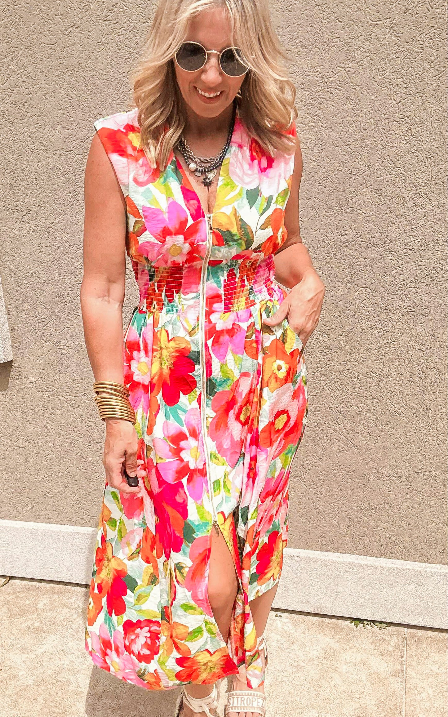 Vibrant floral summer dress with front zipper, wide straps, and flattering smocked waist.