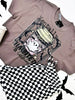 Gray t-shirt with graphic design featuring a coffee cup and text that says "Mentally Haunted and Caffinated", placed on a white surface.