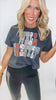 Woman wearing a dark gray t-shirt with colorful graphic design on a white background