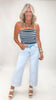 Woman wearing a striped top and light blue jeans on a white background