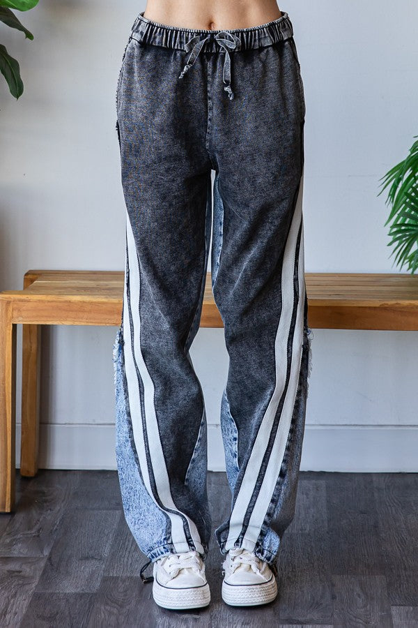 Two tone black and gray oversized denim jeans with contrast side stripe detail.