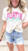 Graphic crop tee with the words Boating in bright fuchsia and Floating in mint cursive font paired with jean shorts
