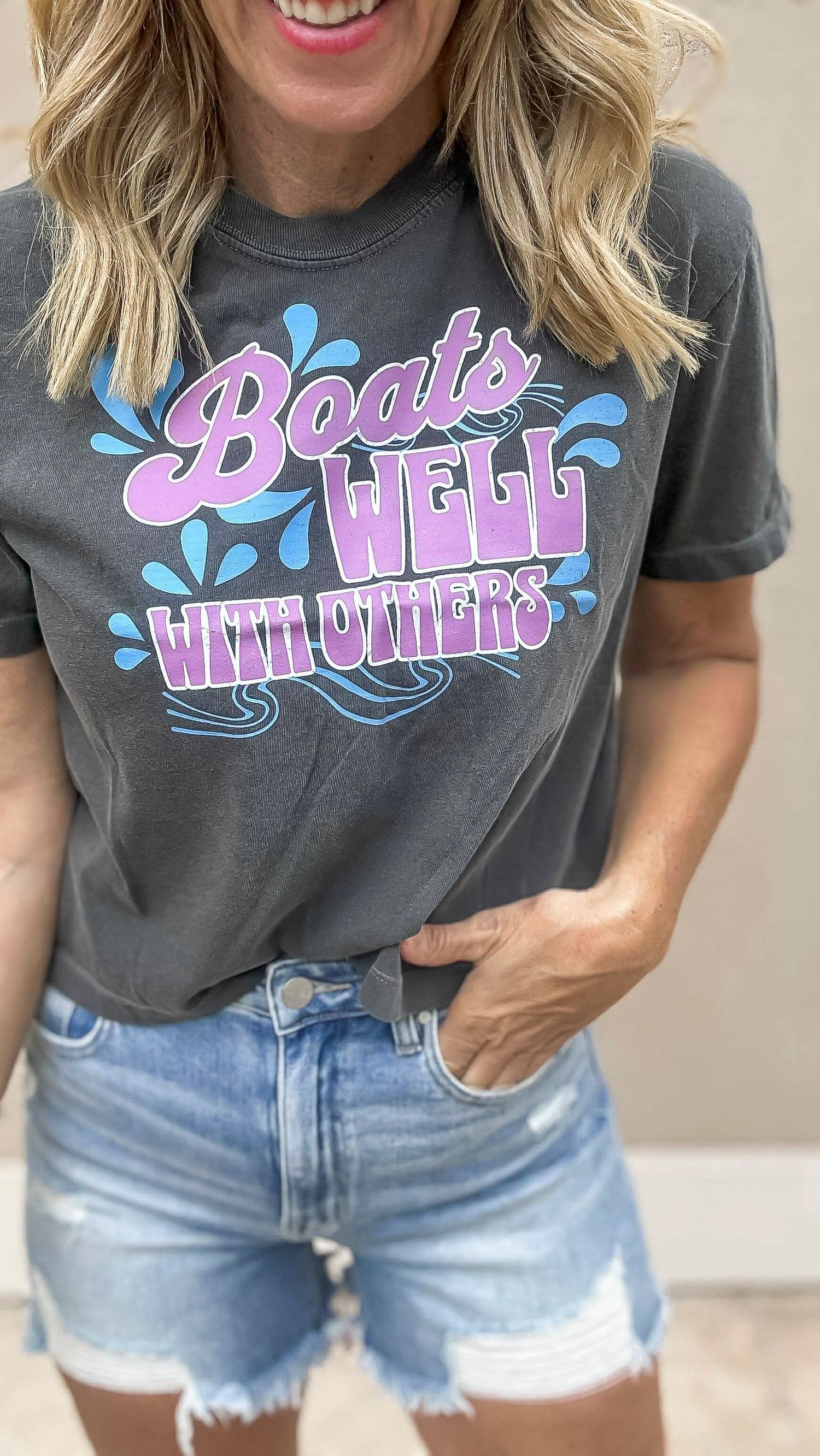 Boats well with others" graphic t-shirt paired with distressed denim shorts