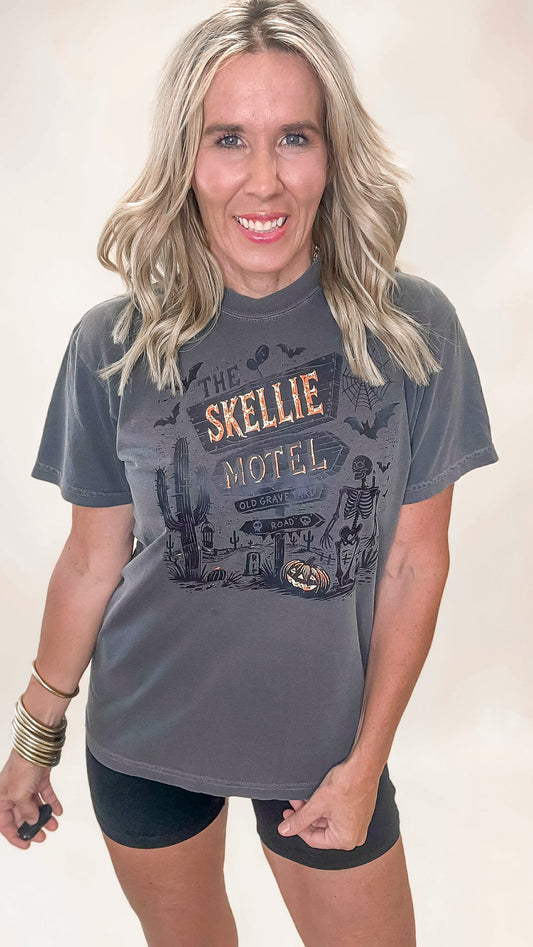 Washed black t-shirt with spooky 'Skellie Motel' Halloween graphic and skeleton design.