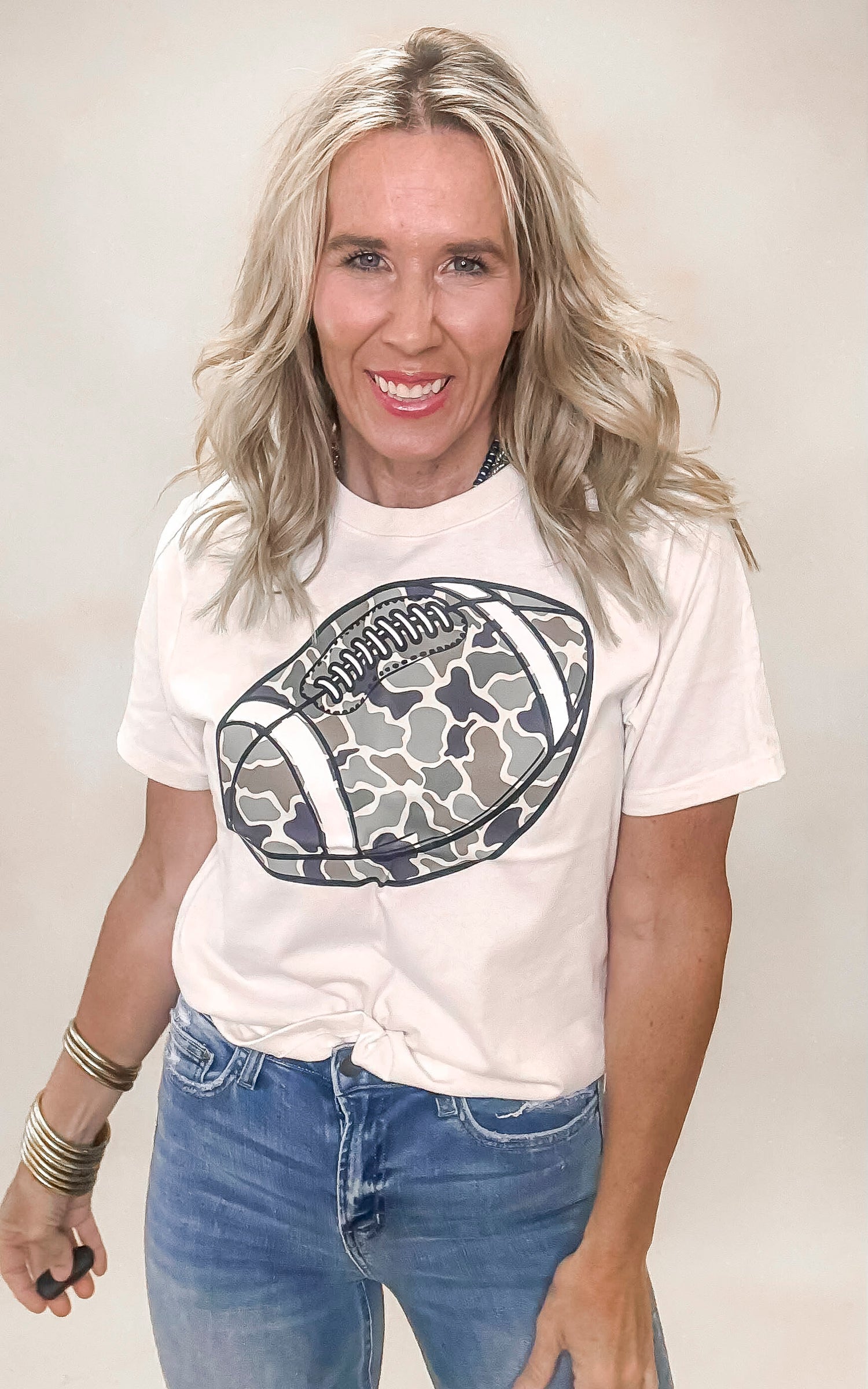 Casual camouflage t-shirt featuring bold football design on front.