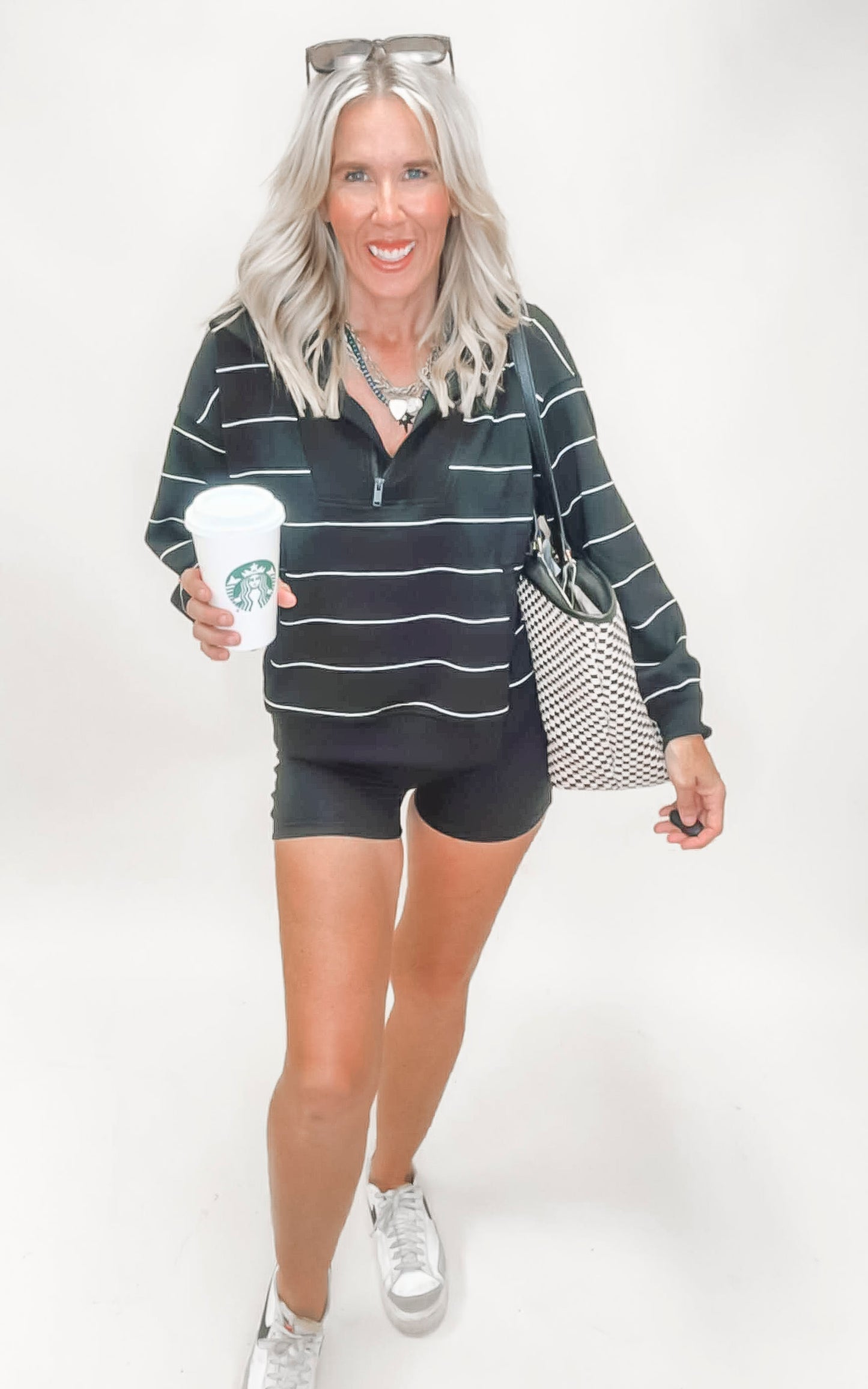 Striped black and white long sleeve quarter zip with mock neck and drop shoulders for a cozy-chic vibe.