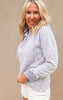 Alina grey striped hooded sweatshirt featuring a henley button-up neckline and relaxed fit, styled with white cutoff shorts.