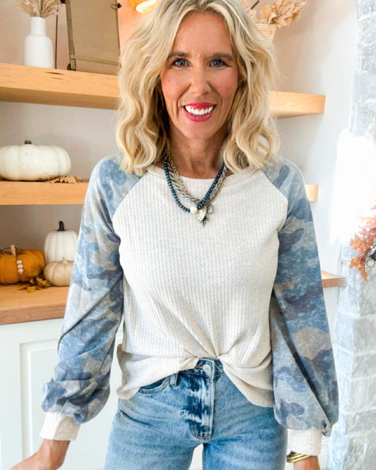 A Long Sleeve Top Featuring Camo Sleeves