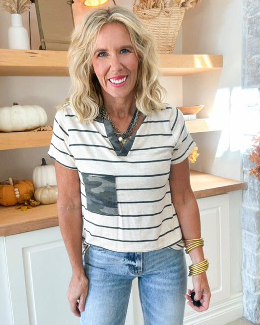 Woman wearing a striped shirt and jeans in a kitchen setting