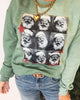Green sweatshirt with a pattern of Santa Claus faces and a gold chain detail.