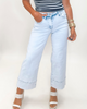 Light blue jeans worn by a person on a plain background