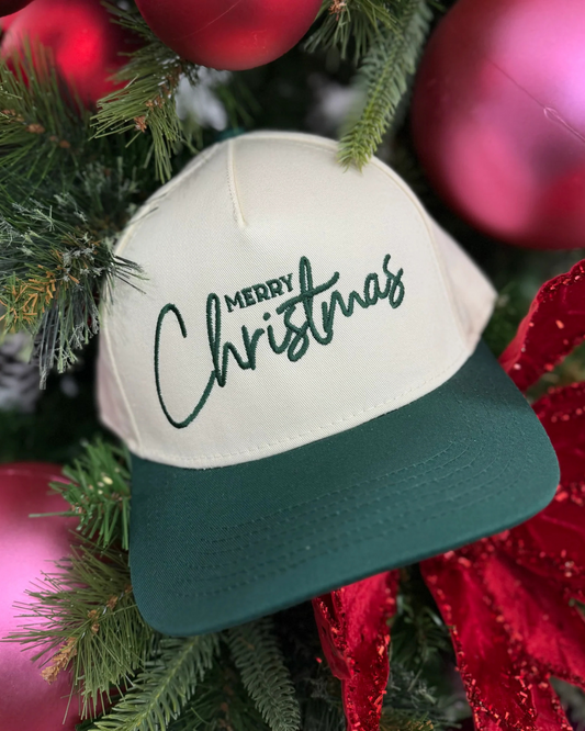 Cap with 'Merry Christmas' text on a Christmas tree with red ornaments.