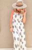 Lightweight boho jumpsuit with a ruched top and black floral embroidery on ivory fabric.
