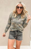 Raelynn camo print crewneck fleece top with a relaxed fit, paired with distressed shorts.
