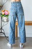 Light wash denim joggers with raw edge distressing styled
