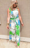 Wide leg jumpsuit featuring a bold green and blue paisley floral print with tie waist and spaghetti straps.