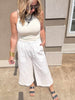 Lightweight white cropped gauze pants paired with fitted ribbed tank top.